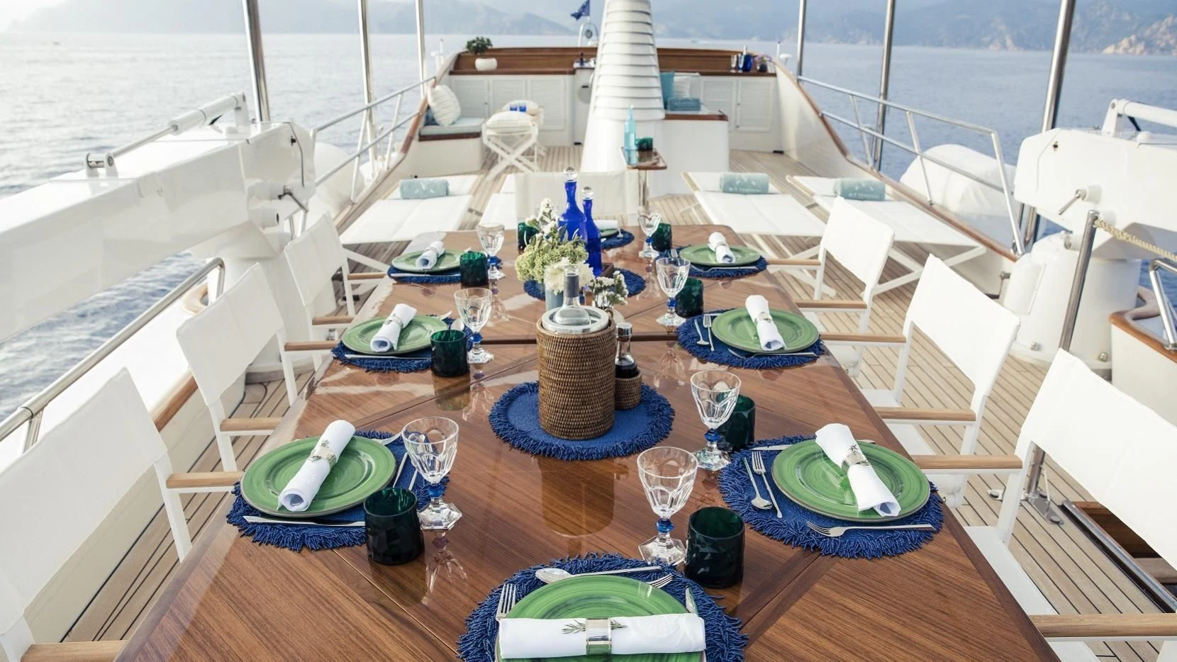 a table with plates and cups on it aboard VESPUCCI Yacht for Sale
