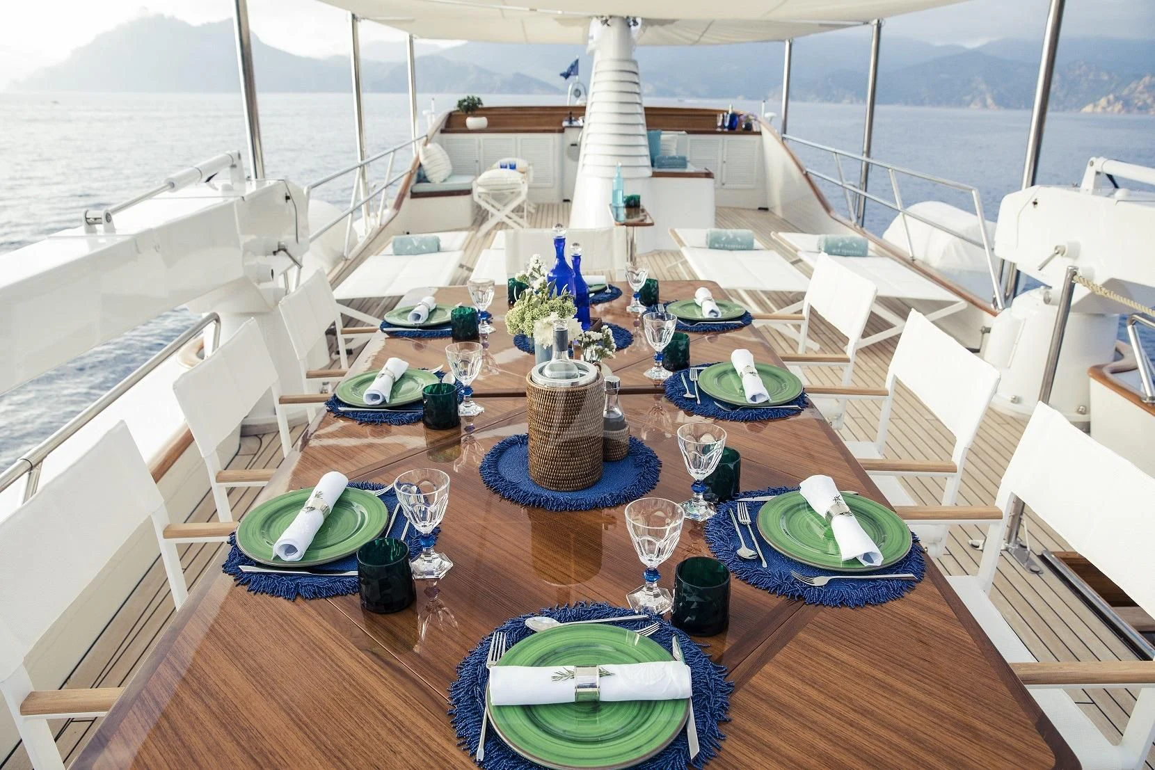 a deck with a table and chairs aboard VESPUCCI Yacht for Sale