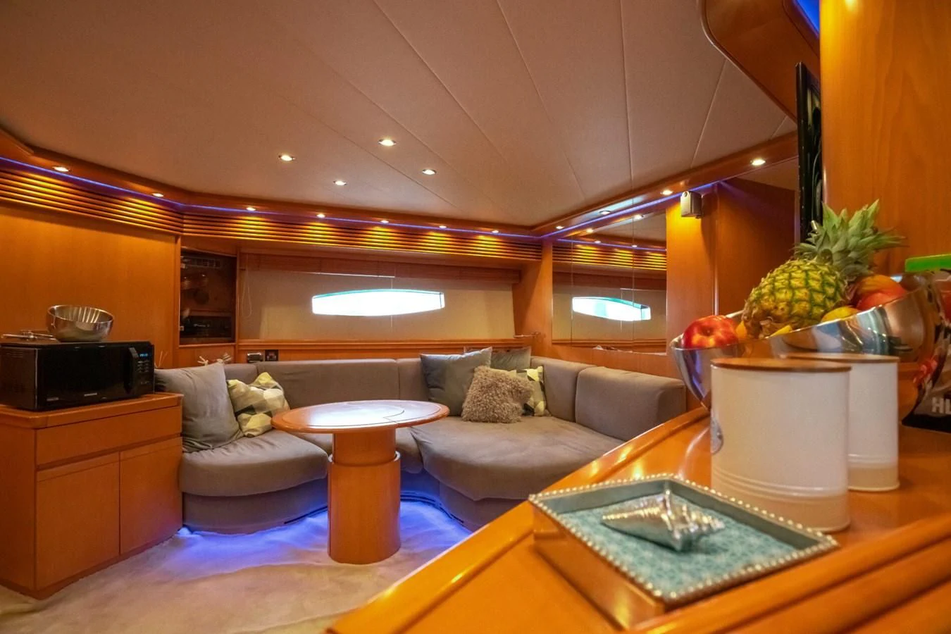 a living room with a couch and a table aboard PERSHING 90 Yacht for Sale