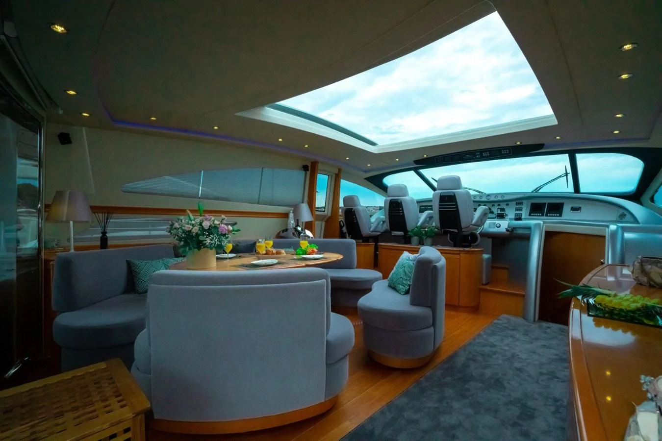 a room with a couch and a table aboard PERSHING 90 Yacht for Sale