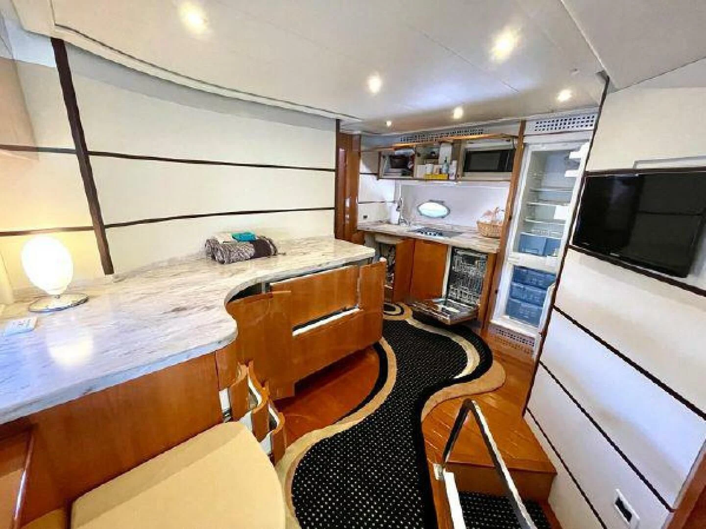 a kitchen with a large island aboard PERSHING 90 Yacht for Sale