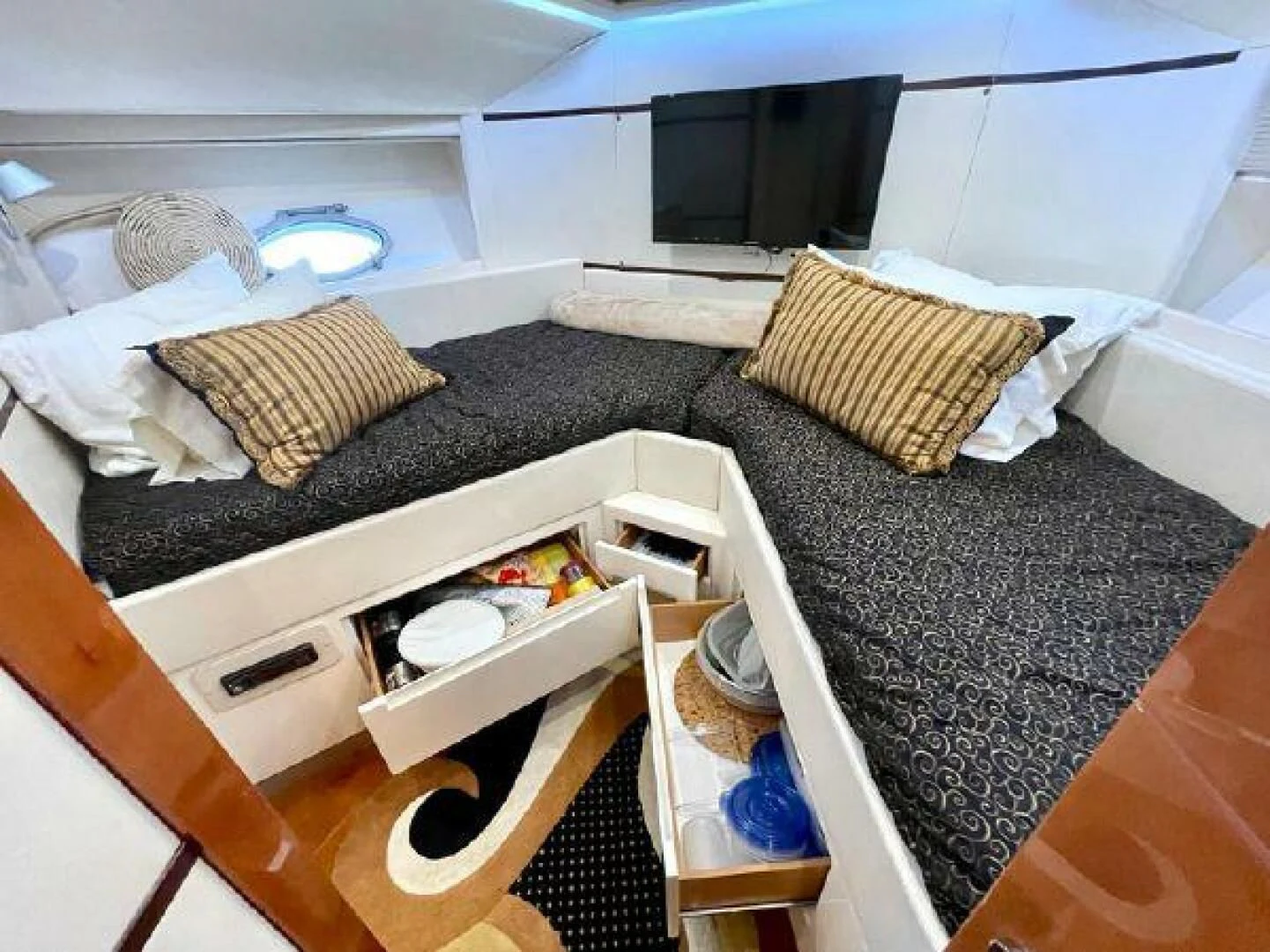 a bed with a black and white rug and a black and white striped rug aboard PERSHING 90 Yacht for Sale