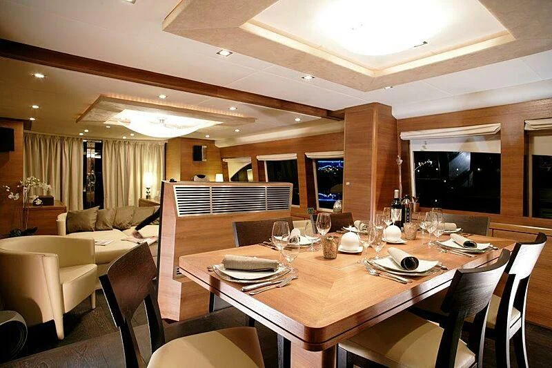 a dining table in a room aboard SUN SHINE 1 Yacht for Sale