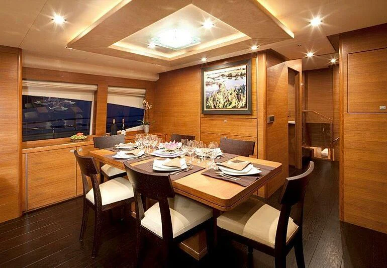 a dining room with a table and chairs aboard SUN SHINE 1 Yacht for Sale