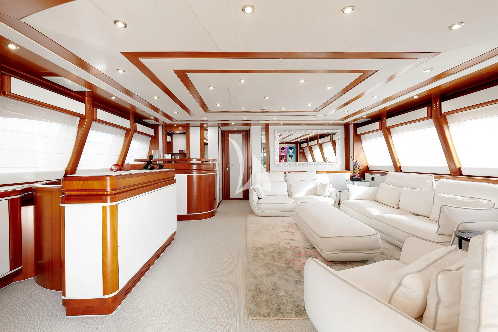 a large room with white couches aboard BUNKER Yacht for Sale