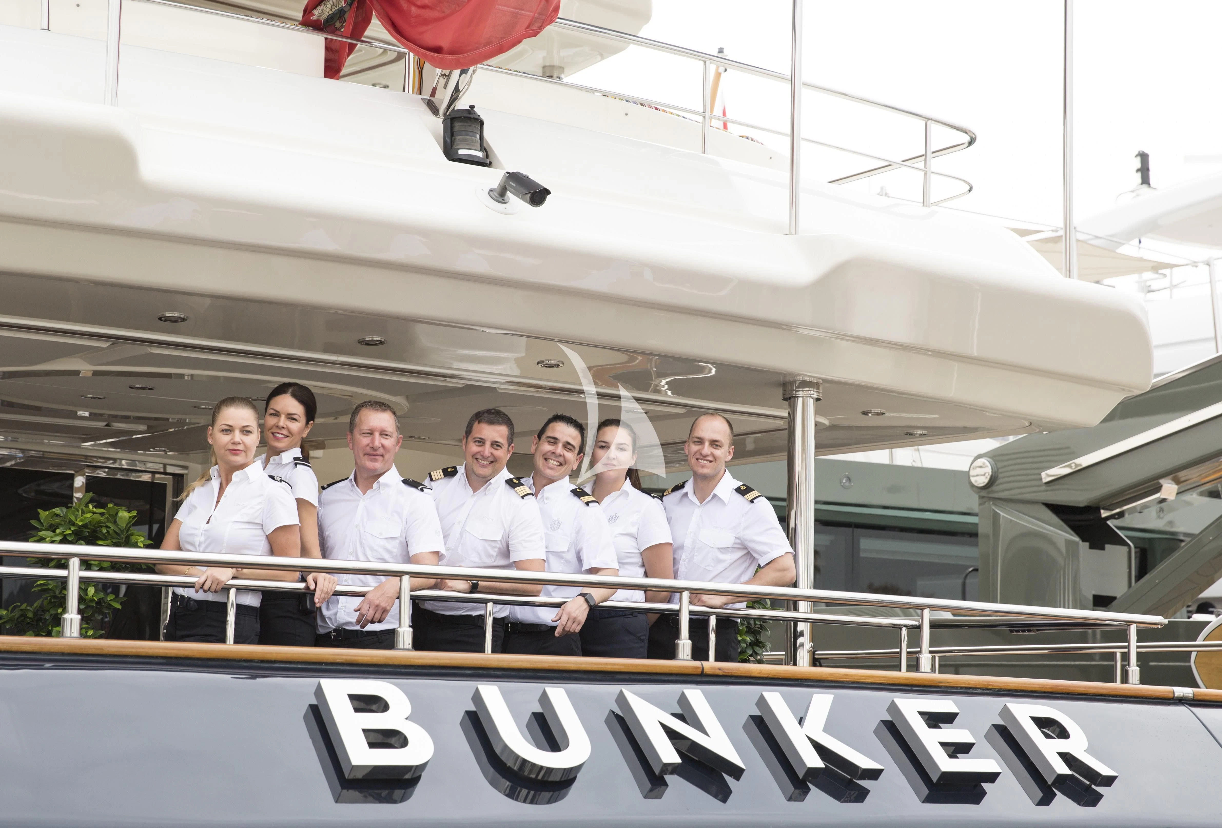 a group of people posing for a photo aboard BUNKER Yacht for Sale