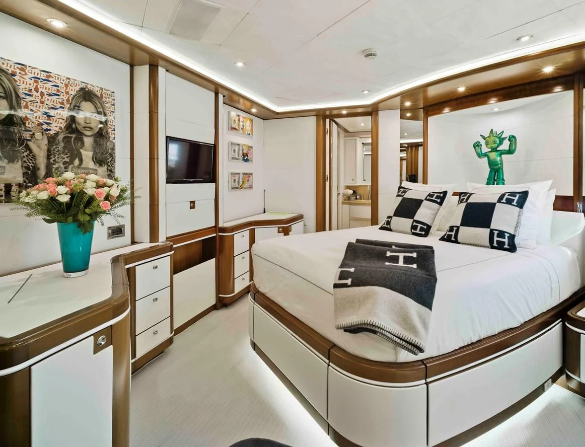 a bedroom with a bed and a desk aboard BUNKER Yacht for Sale