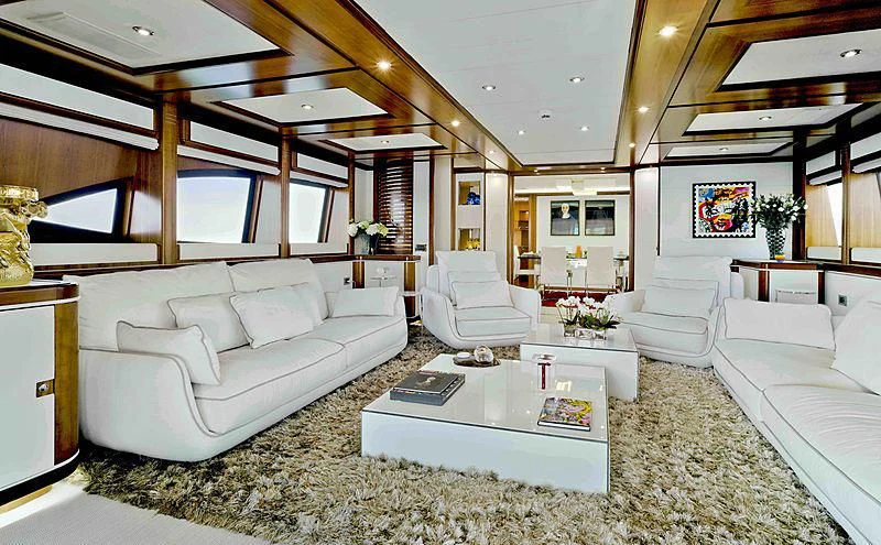 a living room with white couches aboard BUNKER Yacht for Sale