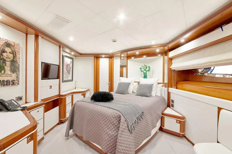 a bedroom with a bed and desk aboard BUNKER Yacht for Sale