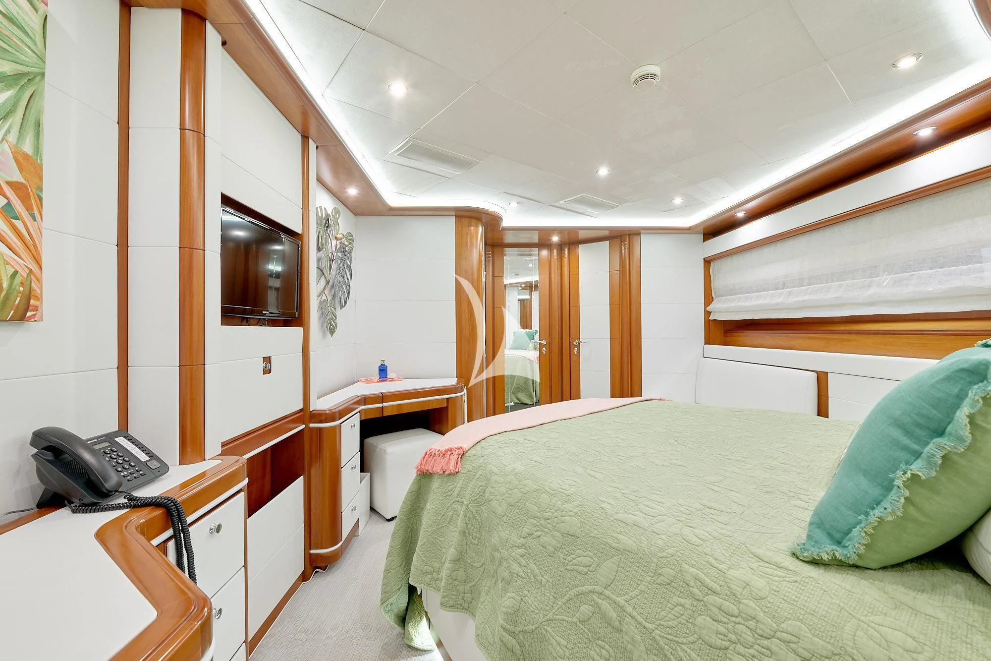 a bedroom with a bed and desk aboard BUNKER Yacht for Sale
