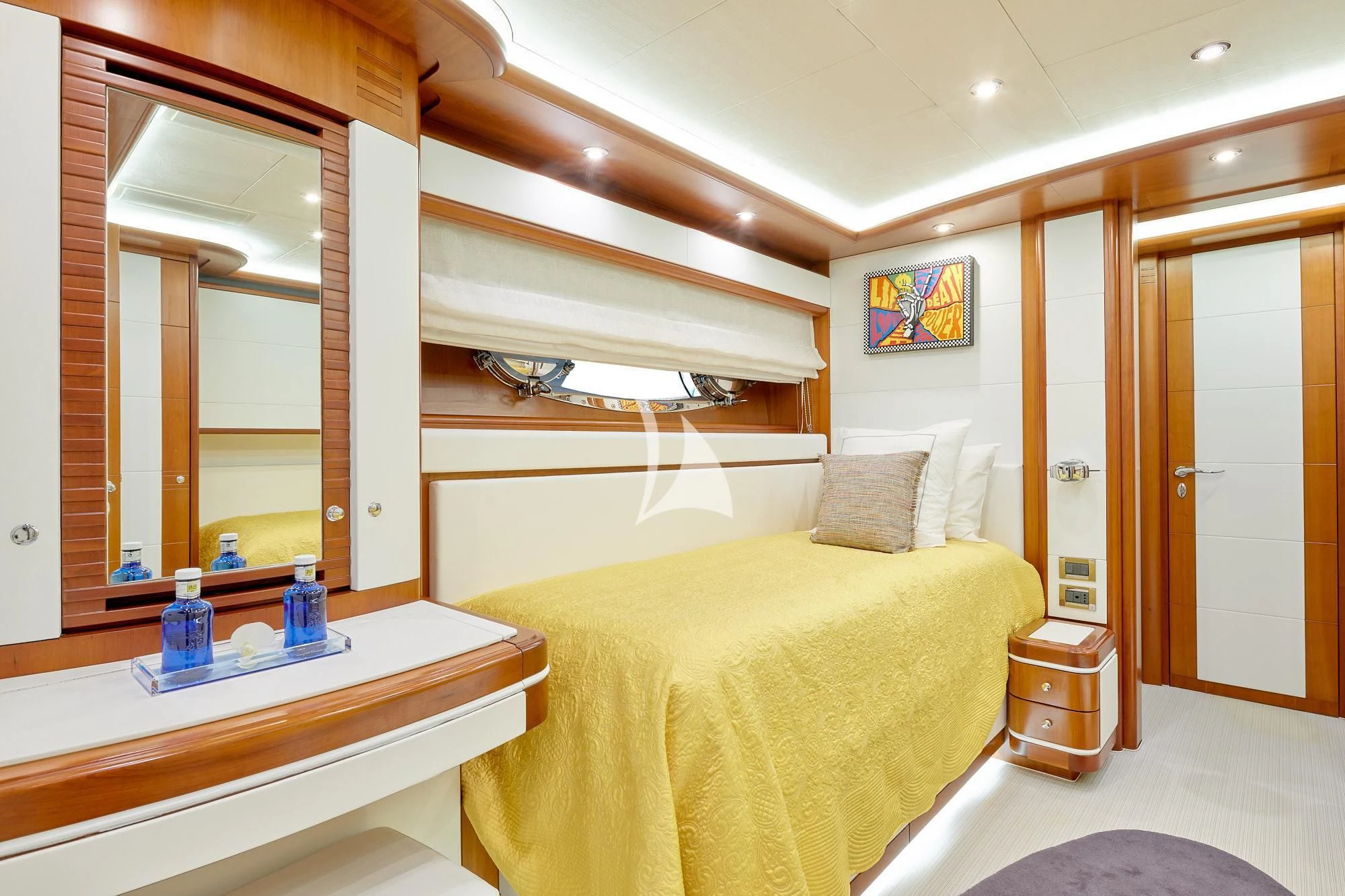 a bedroom with a bed and a mirror aboard BUNKER Yacht for Sale
