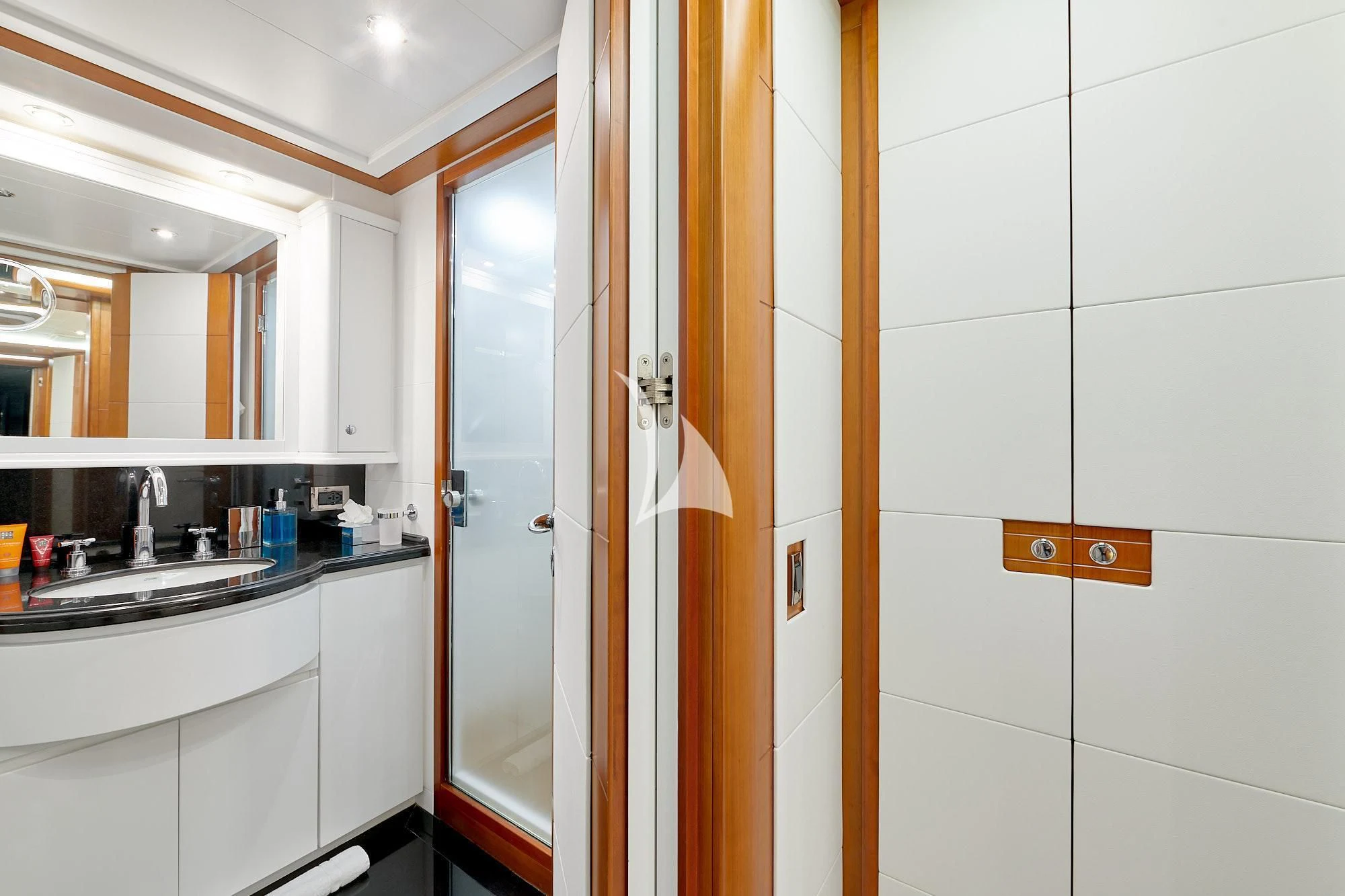 a bathroom with a door and a mirror aboard BUNKER Yacht for Sale