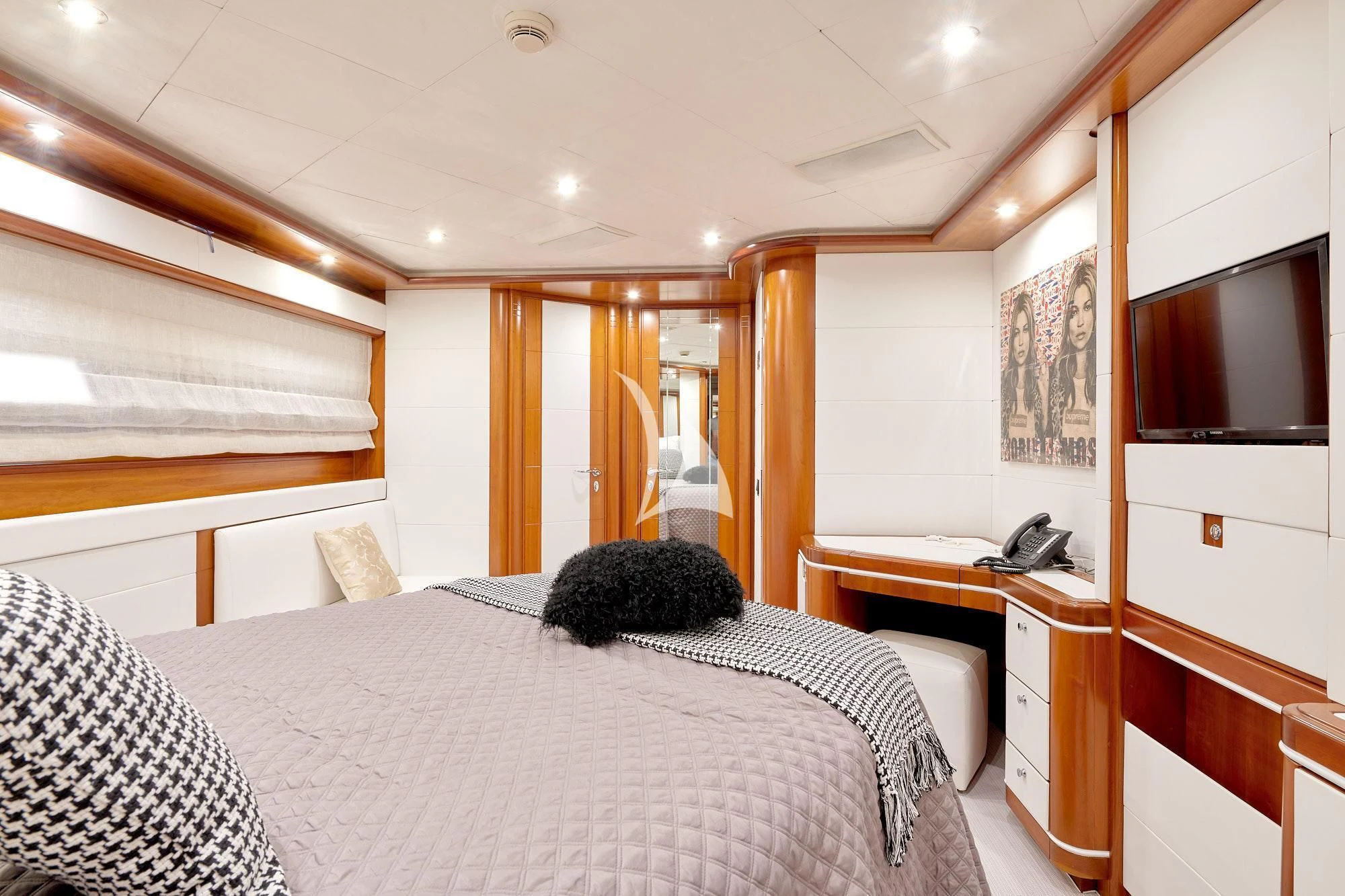 a bedroom with a bed and desk aboard BUNKER Yacht for Sale