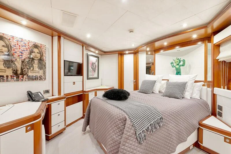 a bedroom with a bed and a desk aboard BUNKER Yacht for Sale