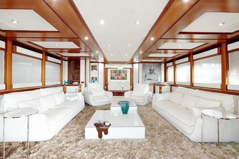 a large room with a couch and a table aboard BUNKER Yacht for Sale