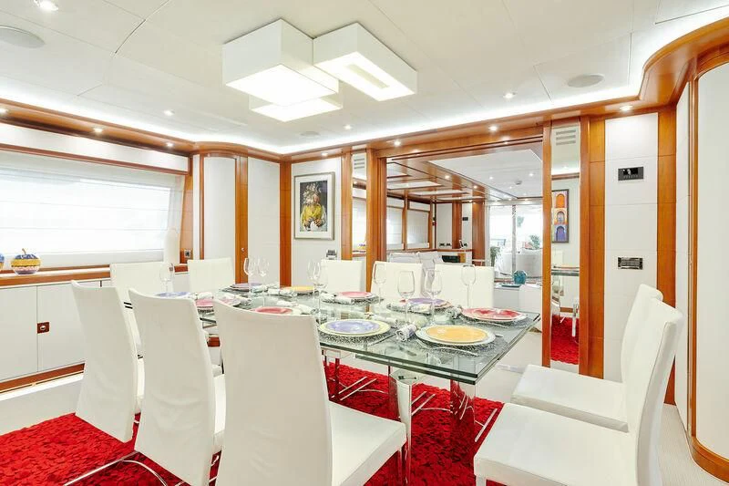 a dining room with white chairs aboard BUNKER Yacht for Sale