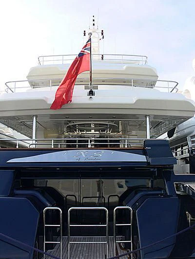 a boat with a flag on the front aboard BUNKER Yacht for Sale