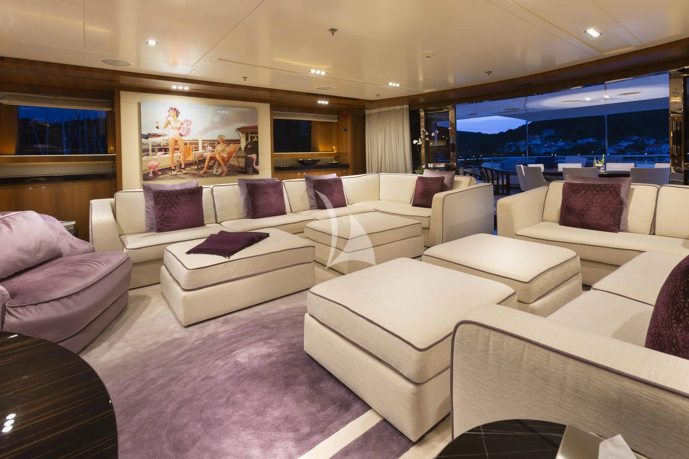 a large living room with a large screen aboard TALEYA Yacht for Sale