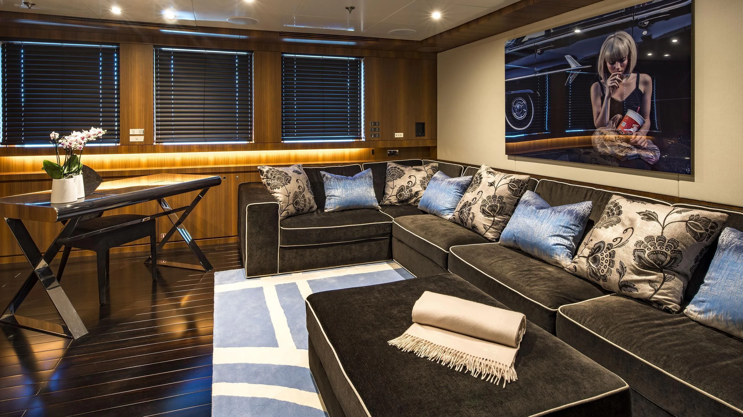 a living room with a couch and a coffee table aboard TALEYA Yacht for Sale