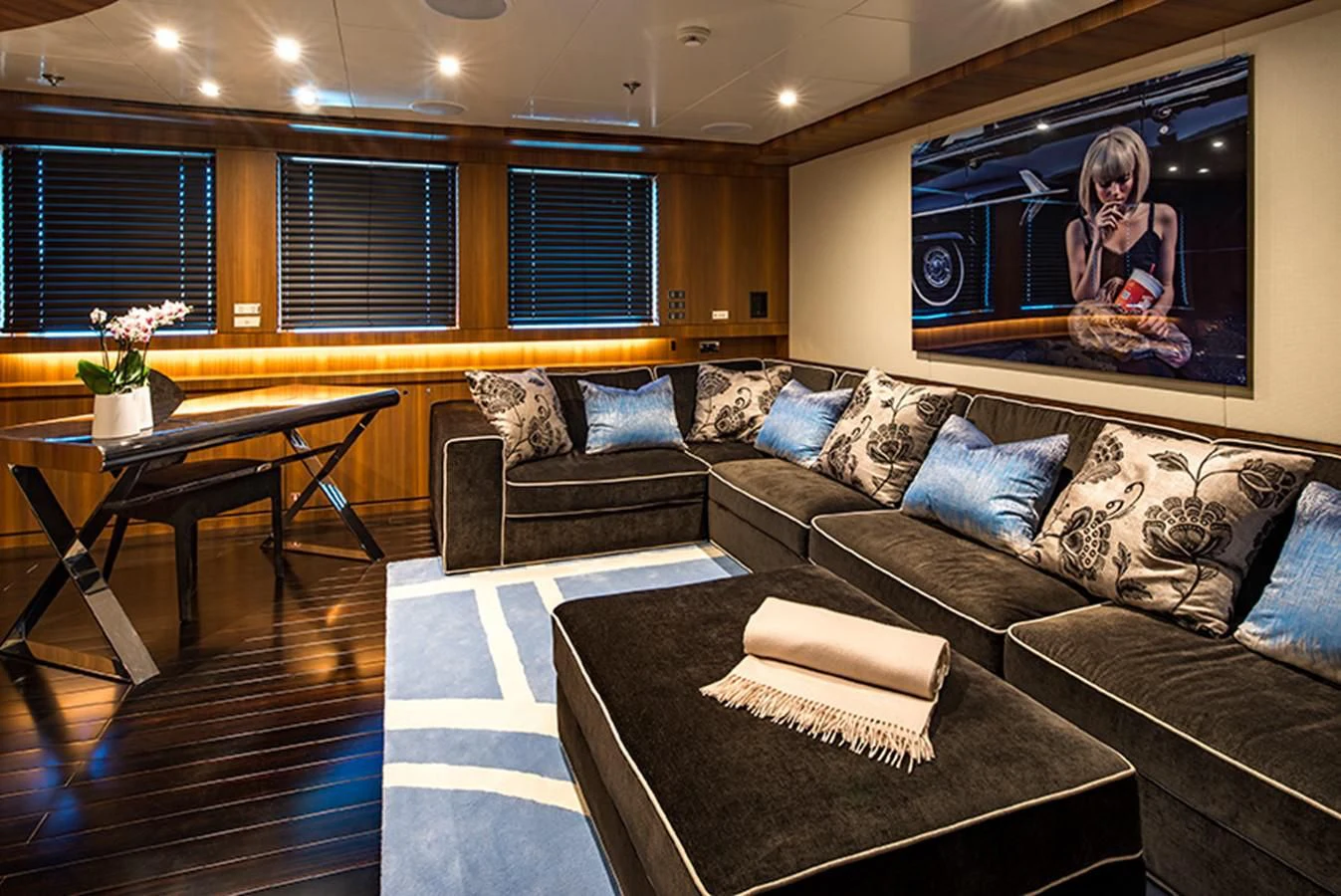 a living room with a couch and a tv aboard TALEYA Yacht for Sale