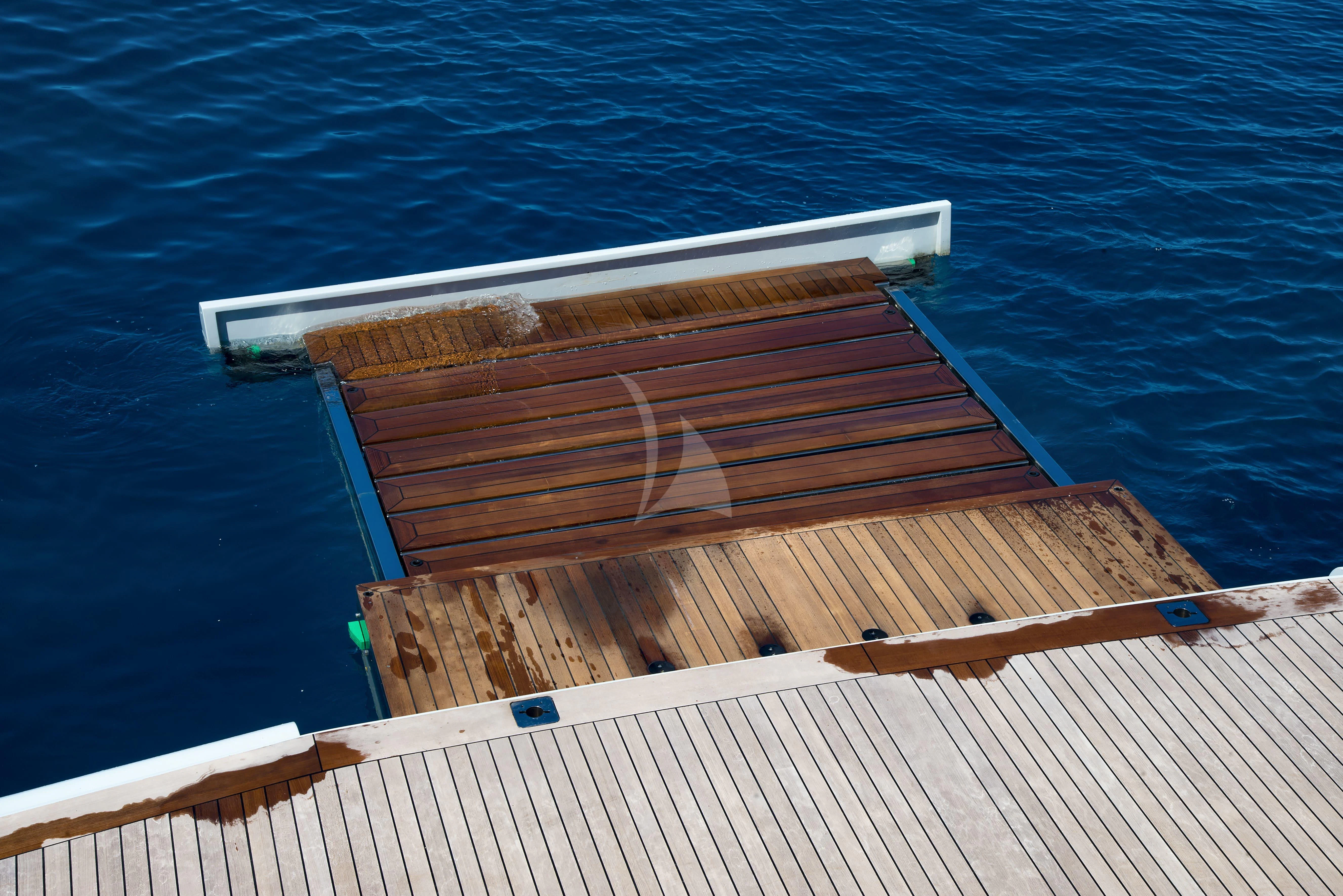 a wooden dock on the water aboard TALEYA Yacht for Sale