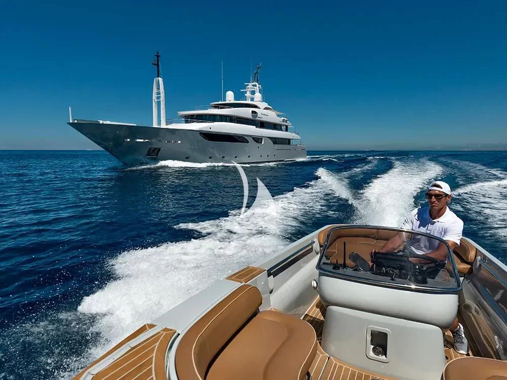 a person driving a boat on the water aboard TALEYA Yacht for Sale