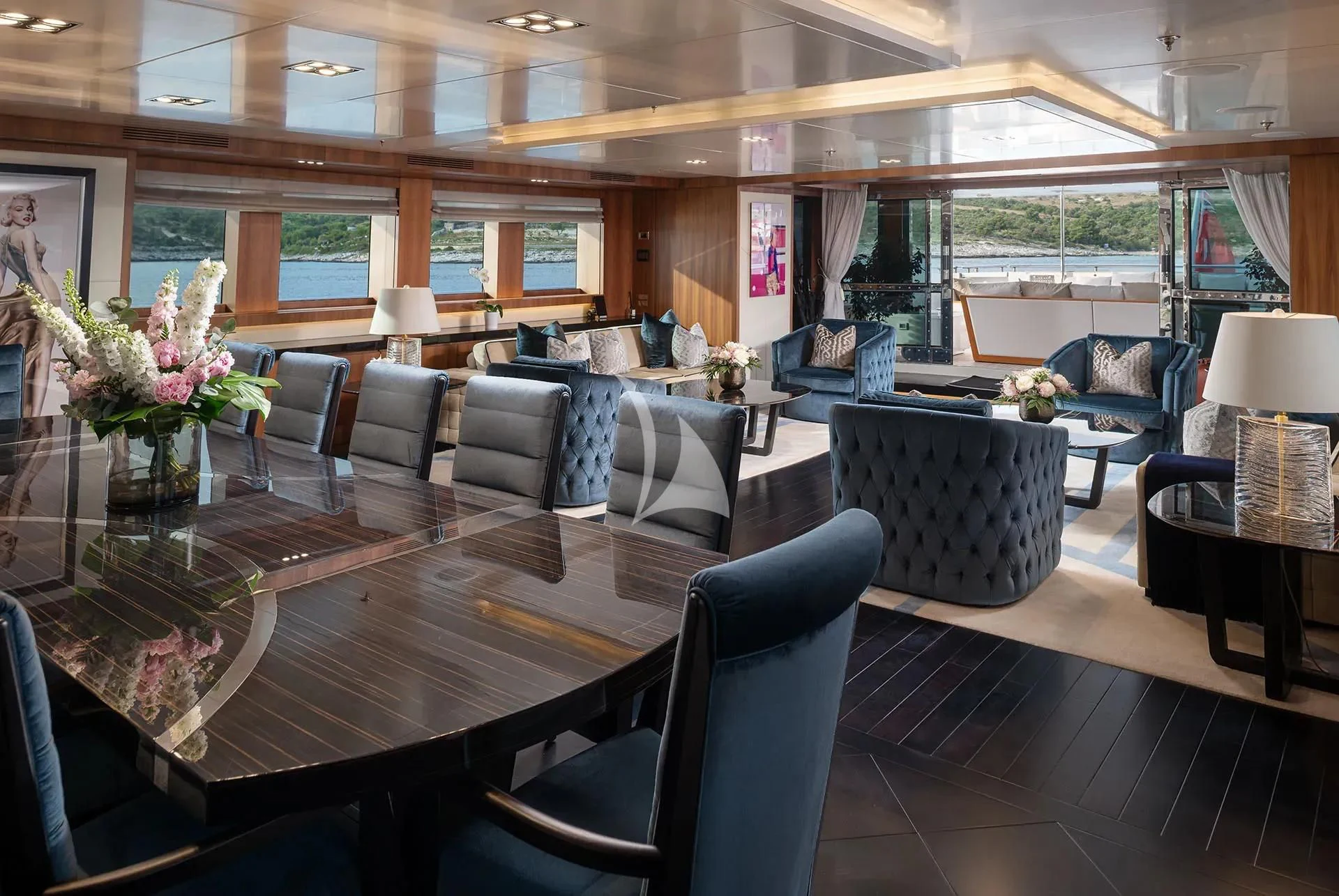 a large room with a table and chairs aboard TALEYA Yacht for Sale