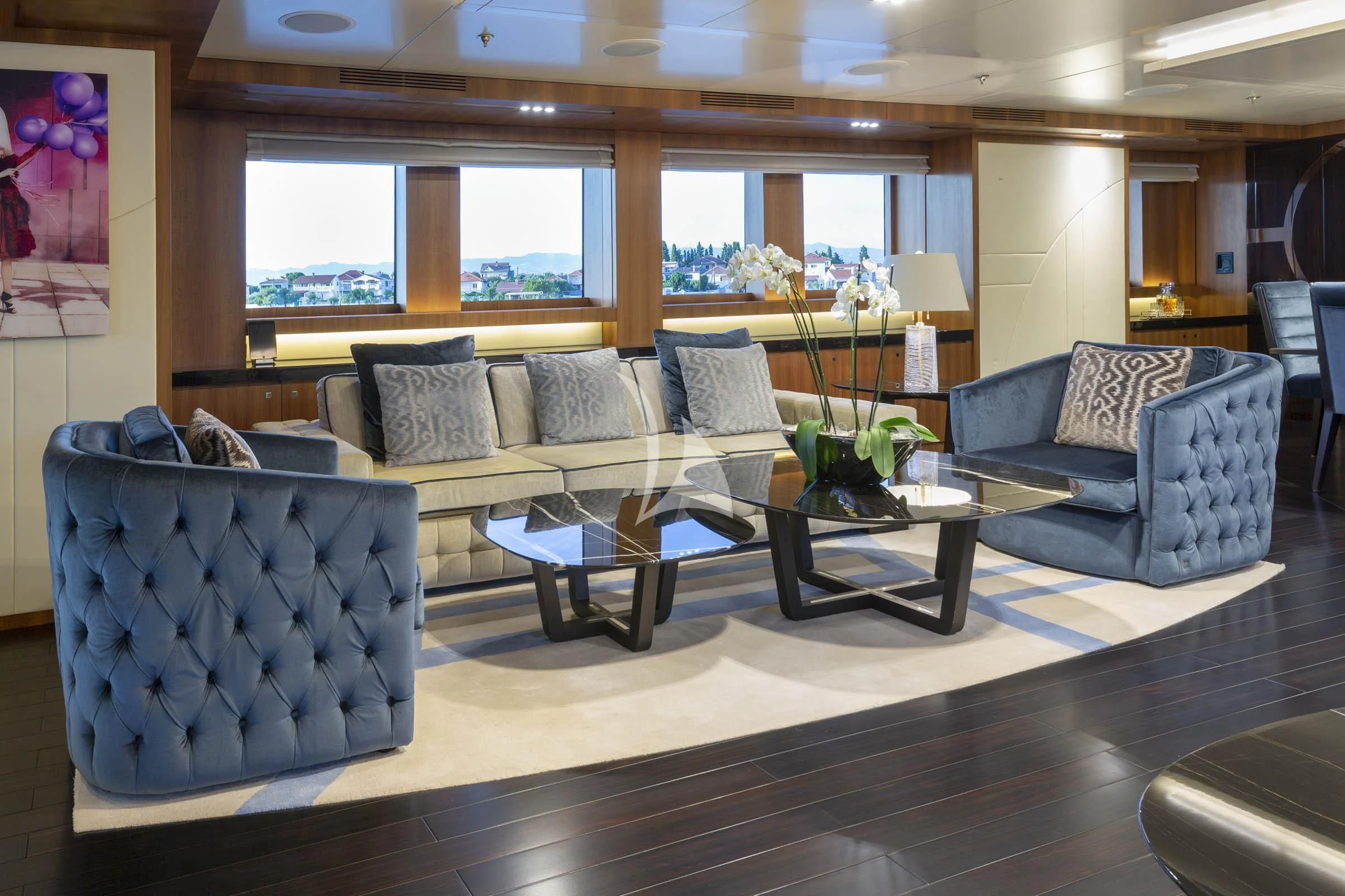 a living room with a couch and a coffee table aboard TALEYA Yacht for Sale