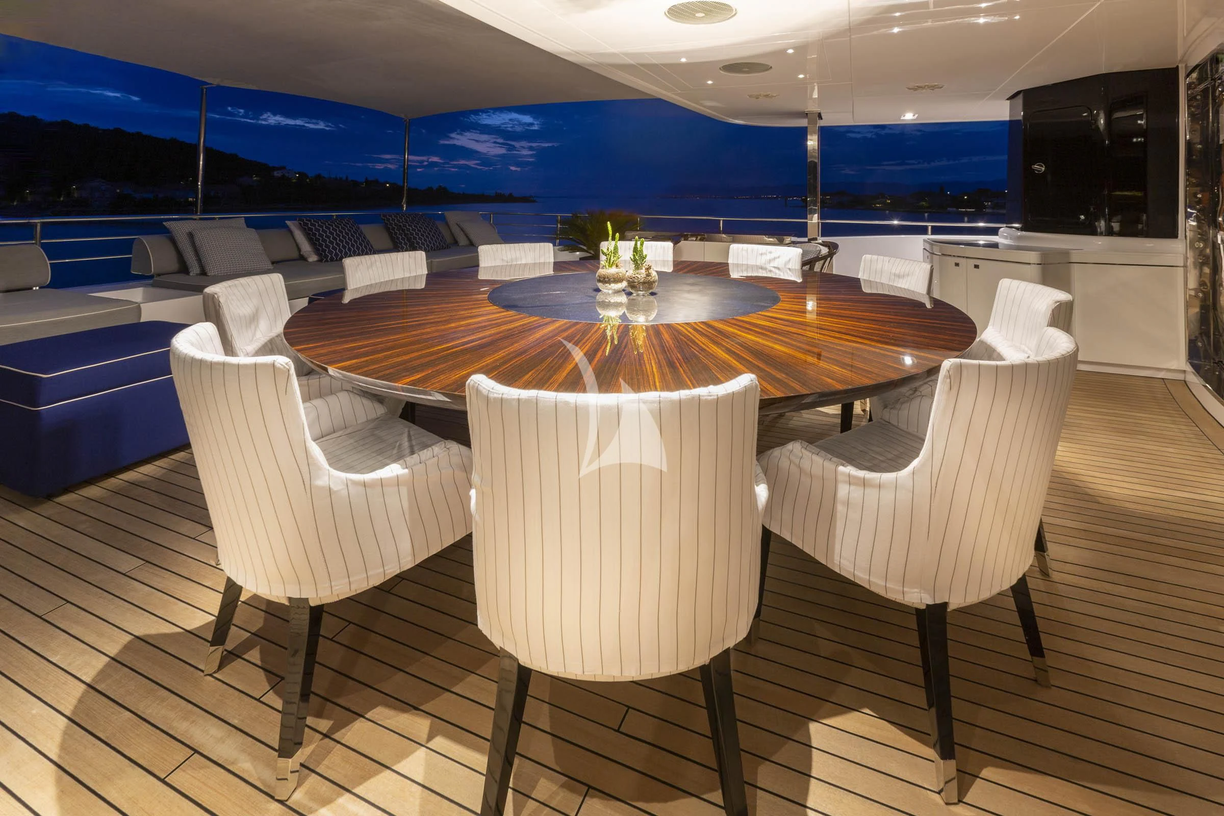 a table with chairs around it aboard TALEYA Yacht for Sale