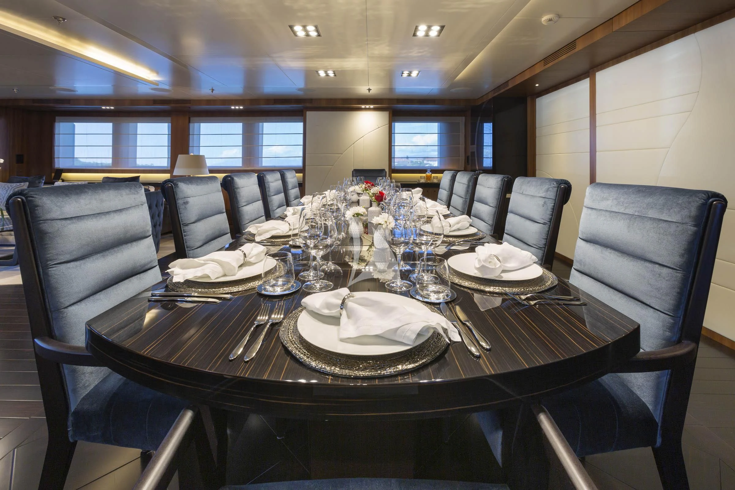 a table set with plates and silverware aboard TALEYA Yacht for Sale
