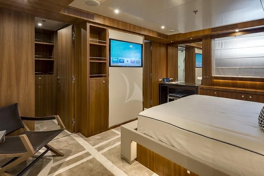 a room with a bed and a tv on the wall aboard TALEYA Yacht for Sale