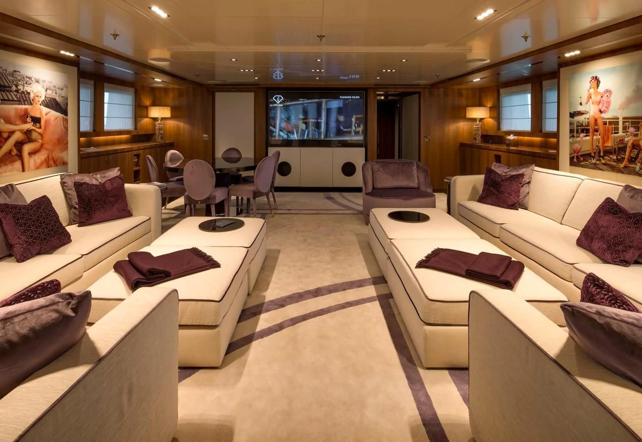 a living room with a large screen aboard TALEYA Yacht for Sale