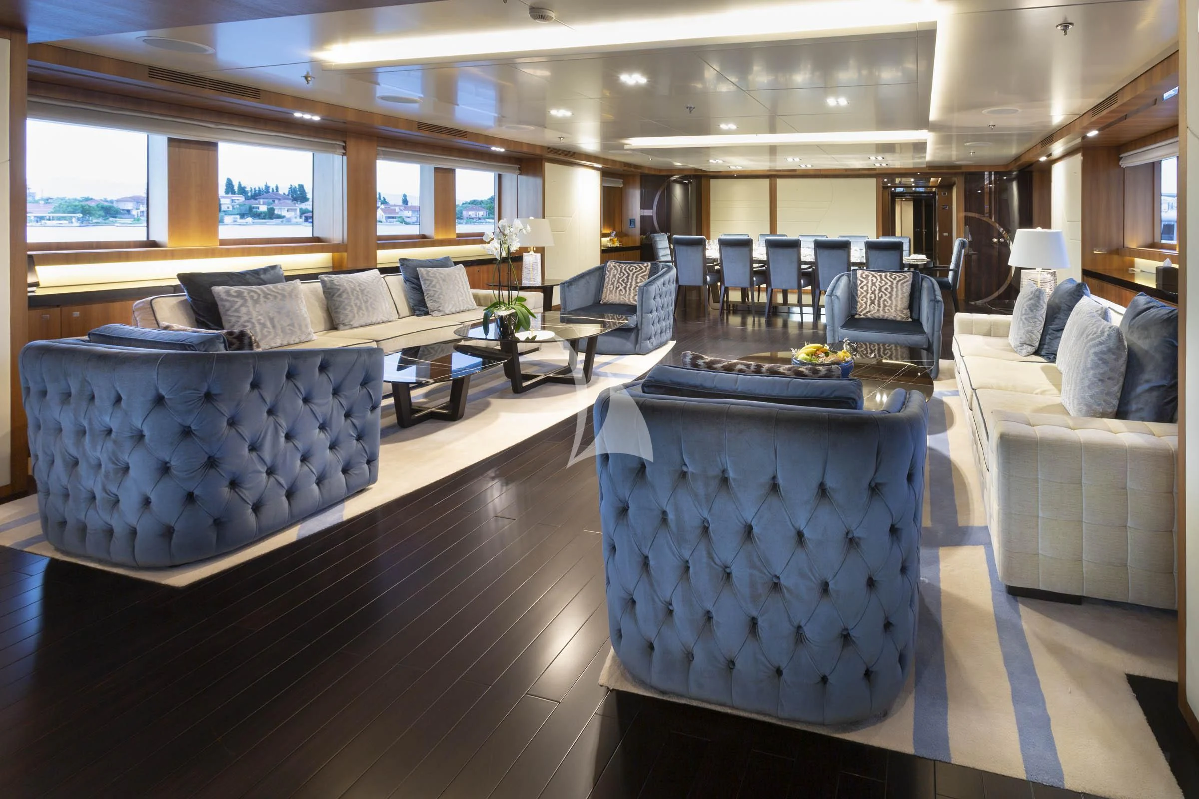 a large room with a table and chairs aboard TALEYA Yacht for Sale