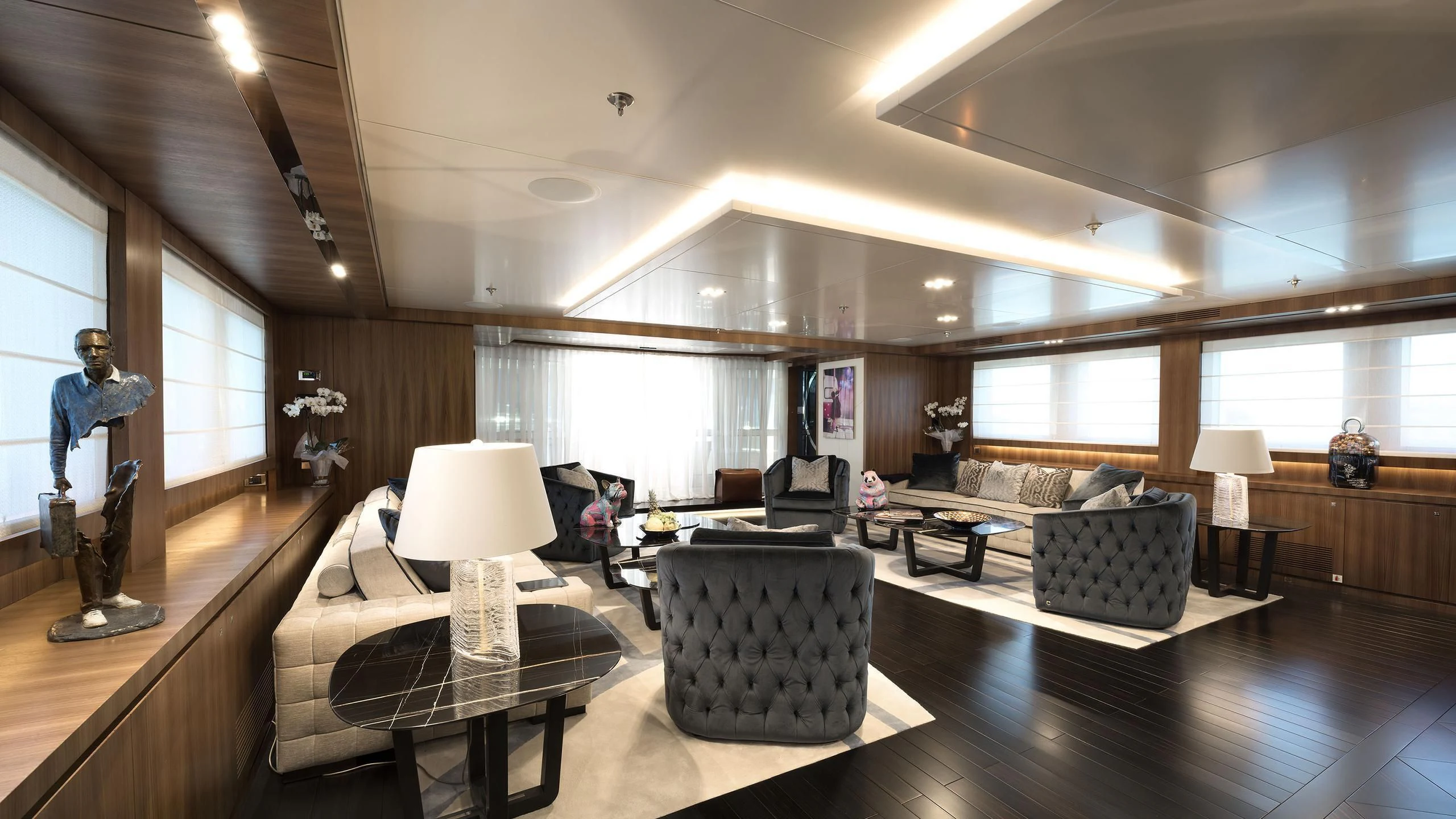 a room with a large mirror and a couch and a table aboard TALEYA Yacht for Sale