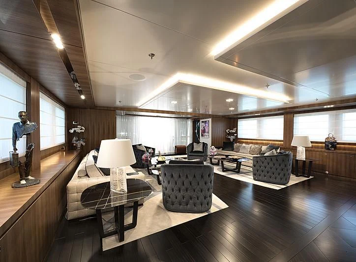 a room with a person playing a guitar aboard TALEYA Yacht for Sale