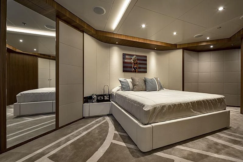 a room with a bed and a desk aboard TALEYA Yacht for Sale