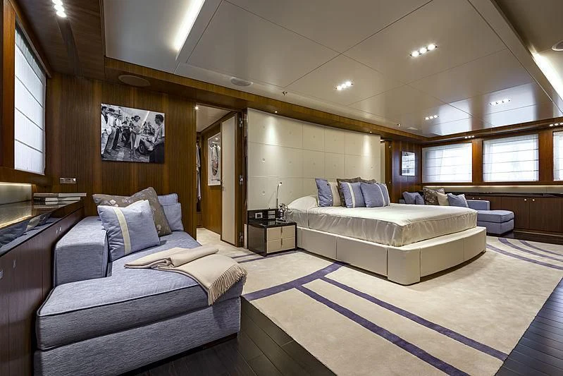 a room with a bed and a couch aboard TALEYA Yacht for Sale