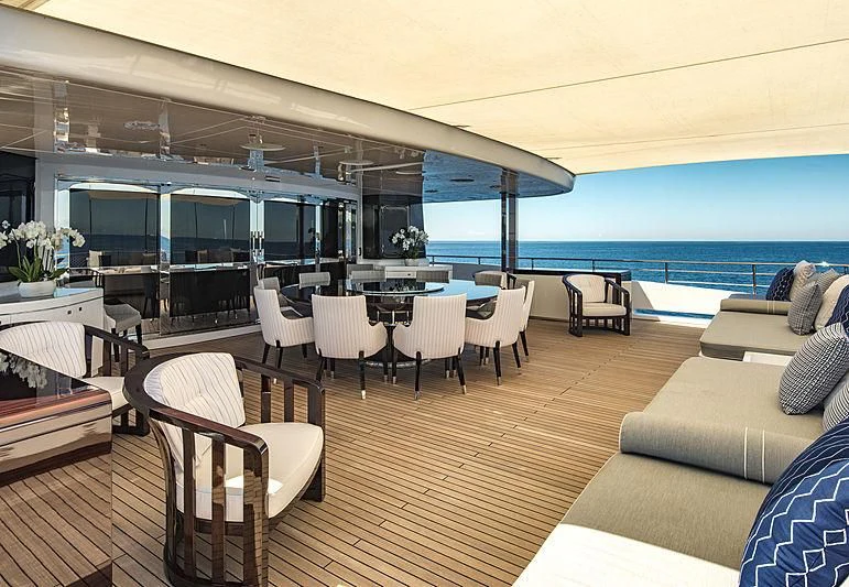 a room with a couch and a table and chairs aboard TALEYA Yacht for Sale