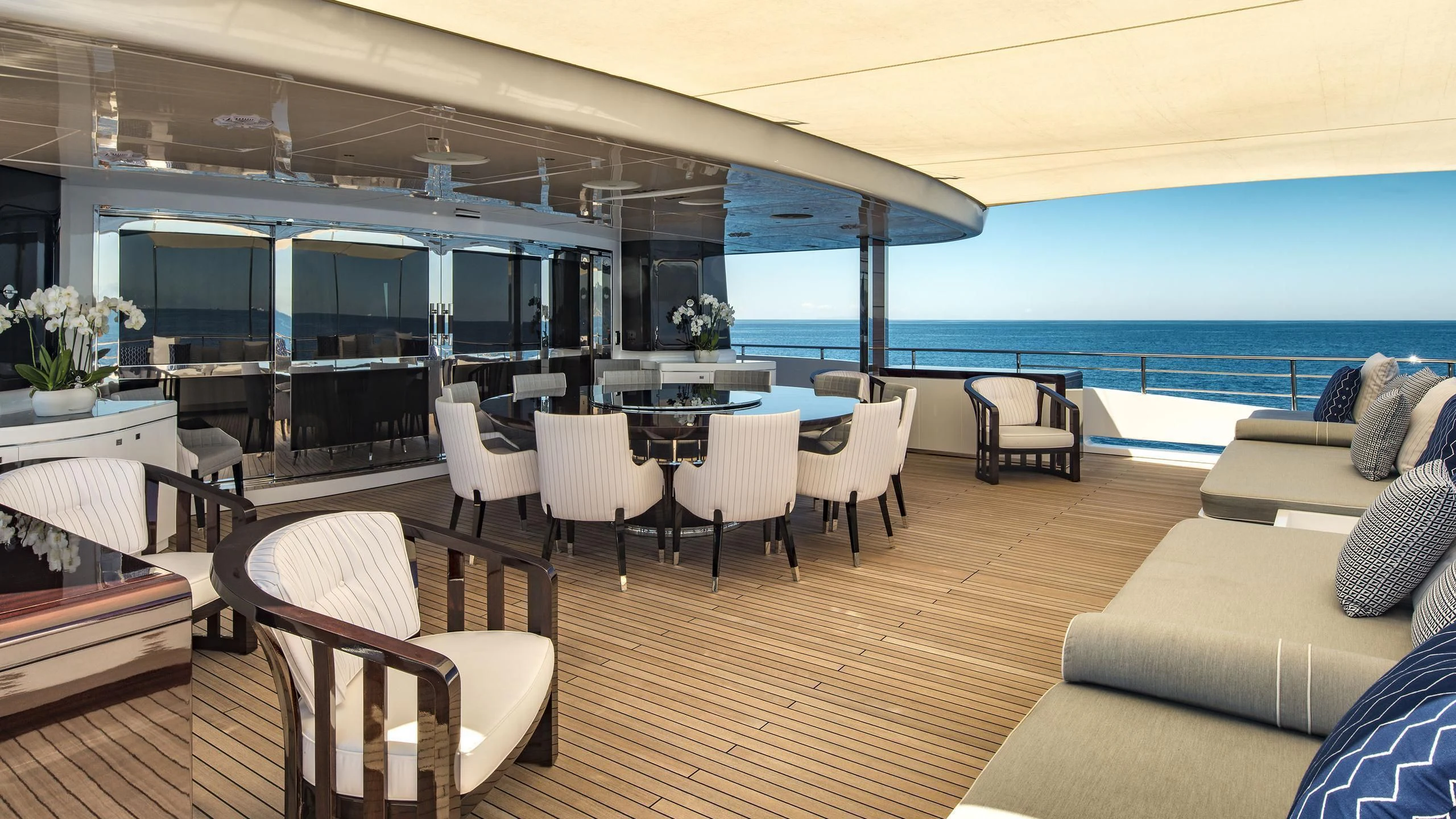 a room with a table chairs and a large window aboard TALEYA Yacht for Sale
