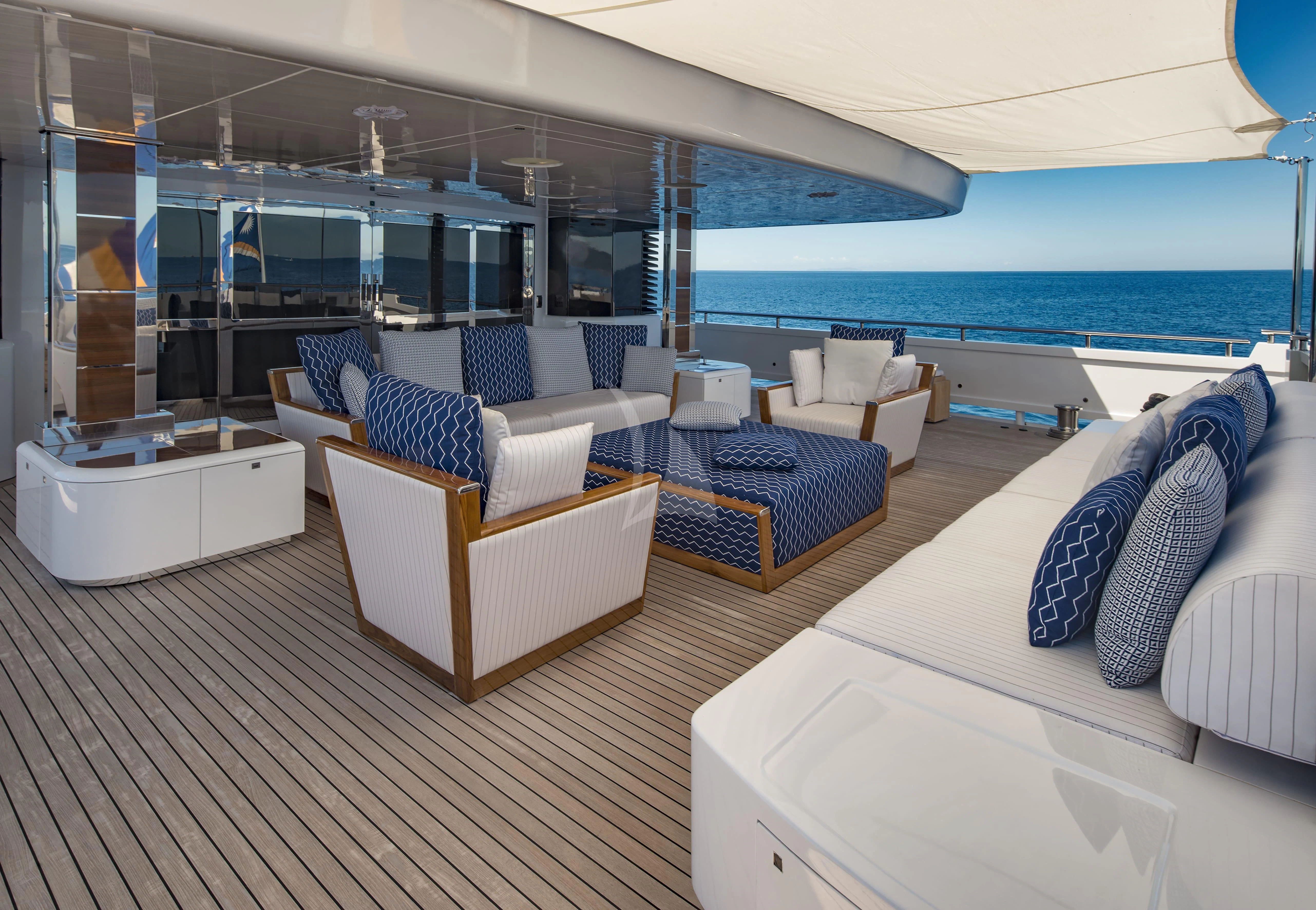 a room with a bed and a couch aboard TALEYA Yacht for Sale
