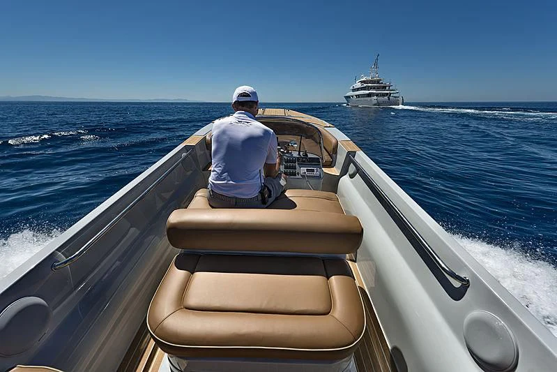 a person driving a boat aboard TALEYA Yacht for Sale