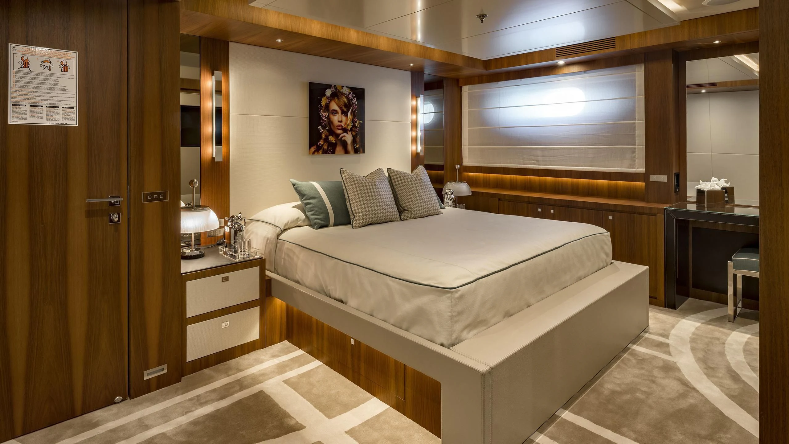 a room with a bed and a desk aboard TALEYA Yacht for Sale