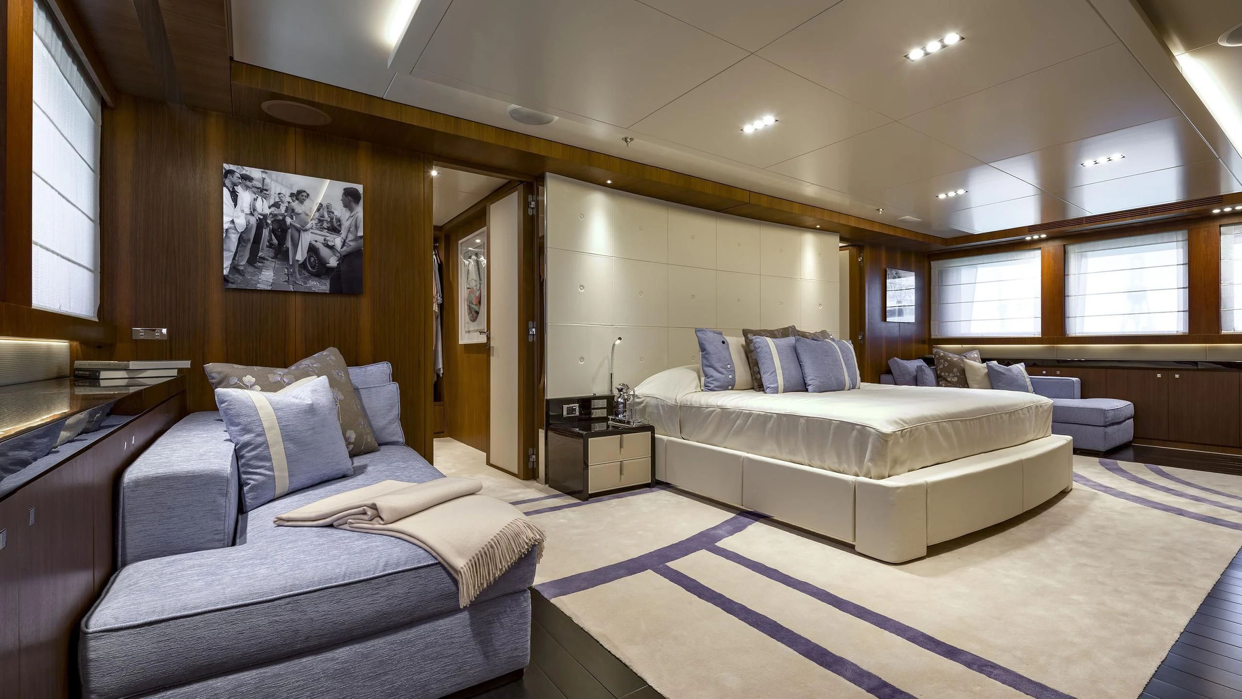 a room with a bed and a couch aboard TALEYA Yacht for Sale