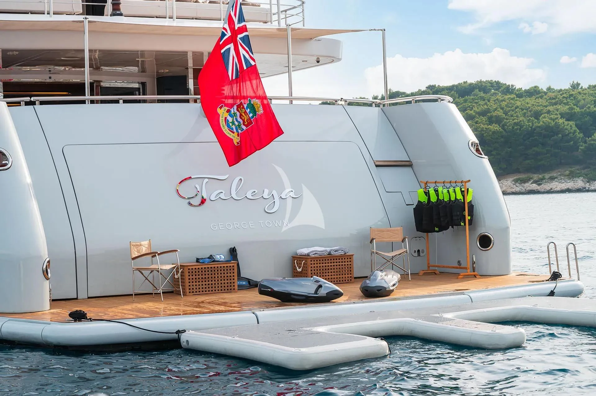 a boat with a flag on the front aboard TALEYA Yacht for Sale