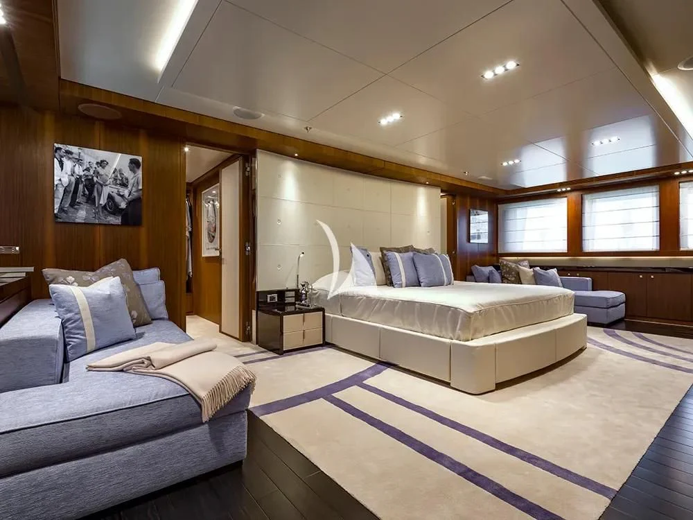 a room with a bed and a couch aboard TALEYA Yacht for Sale