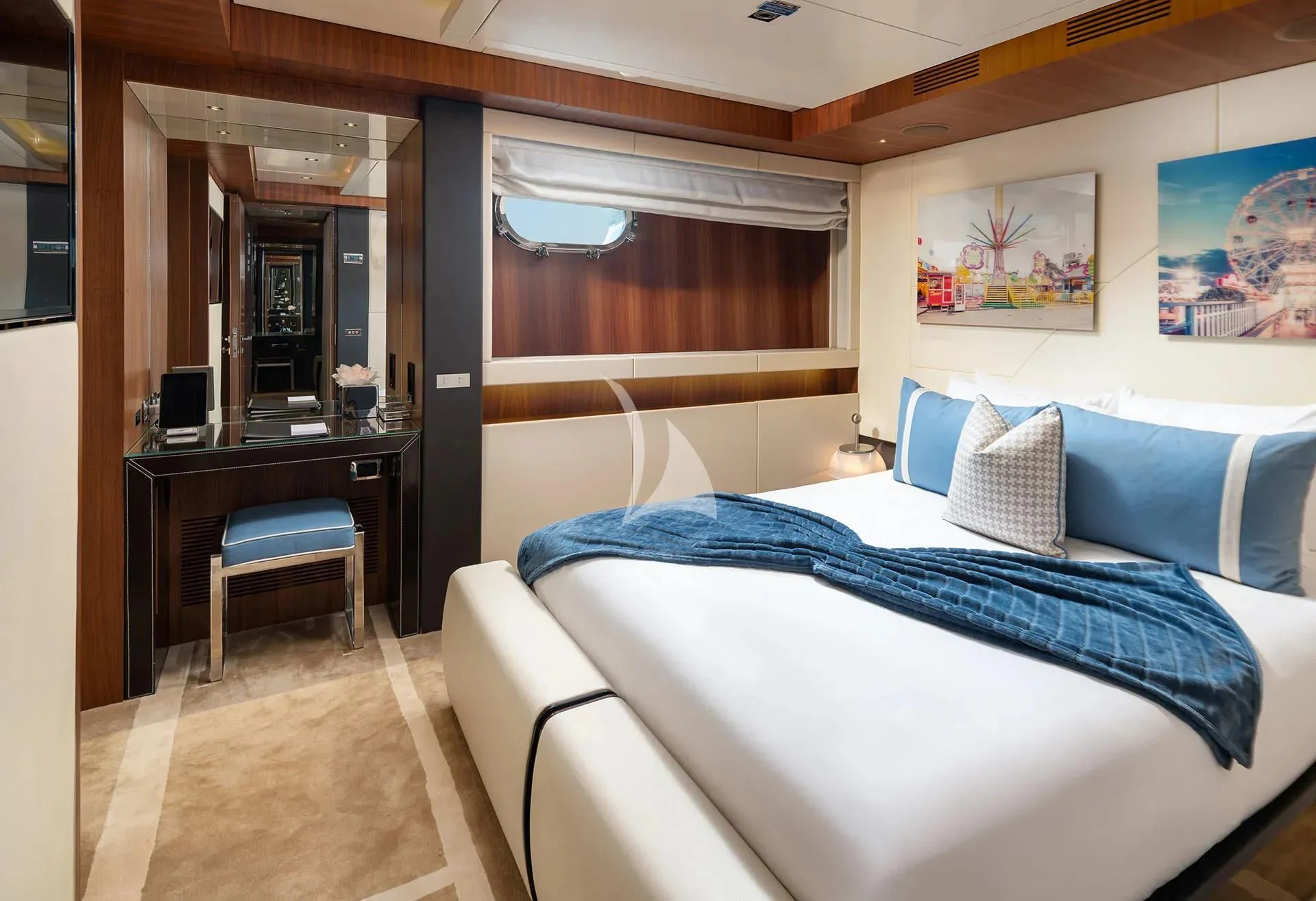 a bedroom with a bed and desk aboard TALEYA Yacht for Sale