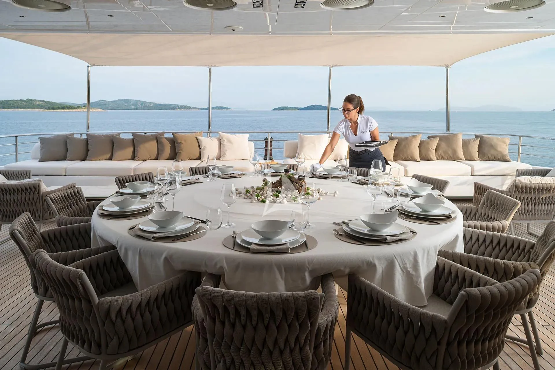 a person sitting at a table aboard TALEYA Yacht for Sale