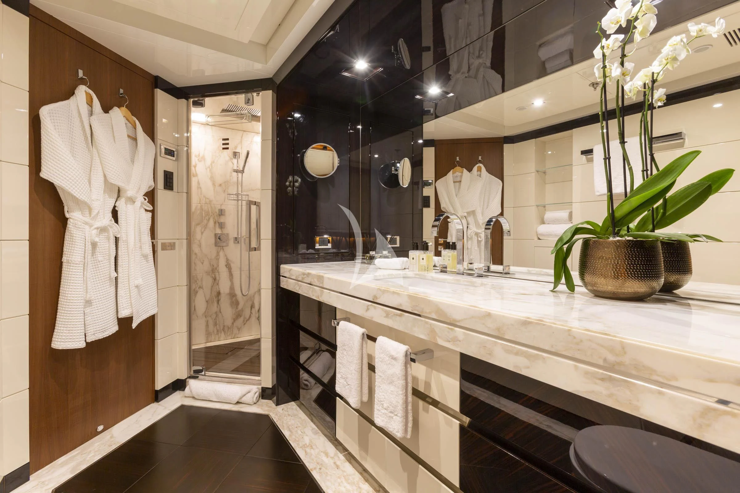 a bathroom with a sink and a large mirror aboard TALEYA Yacht for Sale