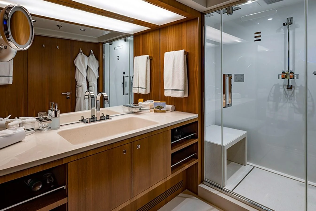 a bathroom with a large mirror aboard TALEYA Yacht for Sale