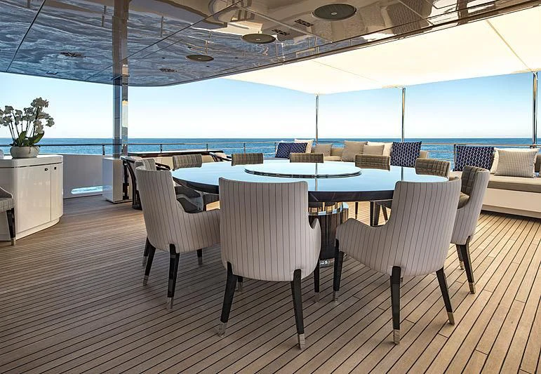 a room with a table and chairs aboard TALEYA Yacht for Sale